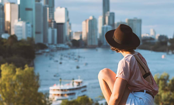 woman looking over water and city